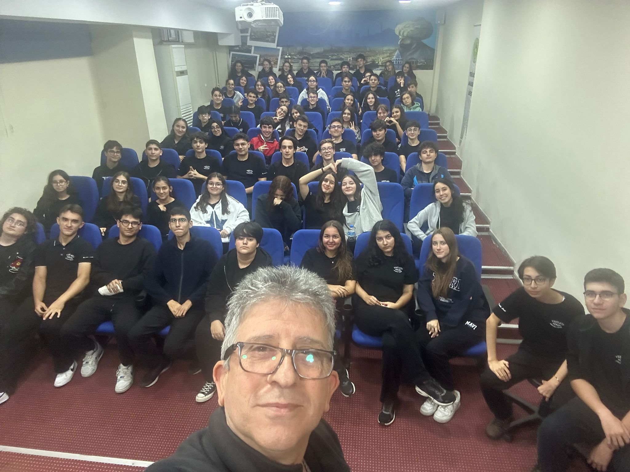 Team selfie in auditorium